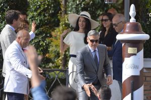 White trouser suit and hat - Amal Alamuddin at the signing the official wedding register.jpg